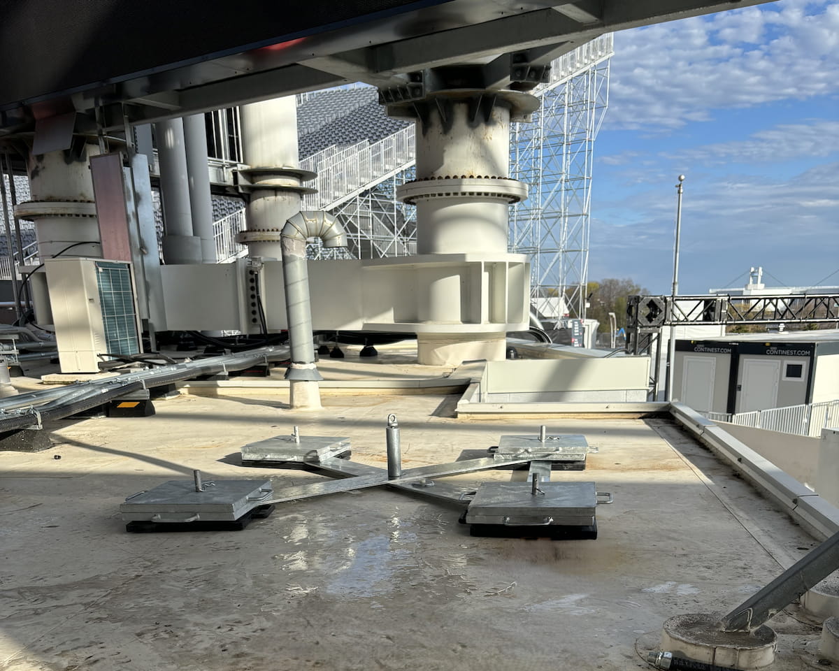 Engineered rooftop deadweight anchor system supporting a temporary horizontal lifeline for safe access around mechanical and electrical equipment at BMO Field