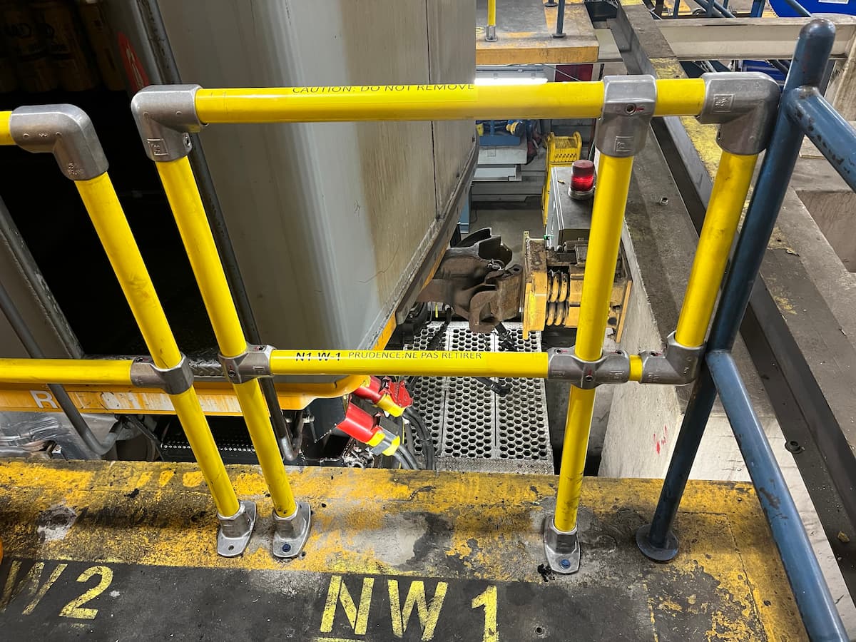 Securely anchored guardrails installed on an rail maintenance platform to meet safety standards