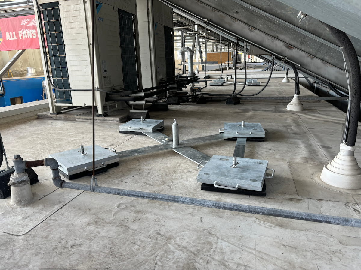 Freestanding horizontal lifeline and deadweight anchor system beneath stadium steel structures at BMO Field, Toronto, supporting FIFA World Cup 2026 rooftop access safety.