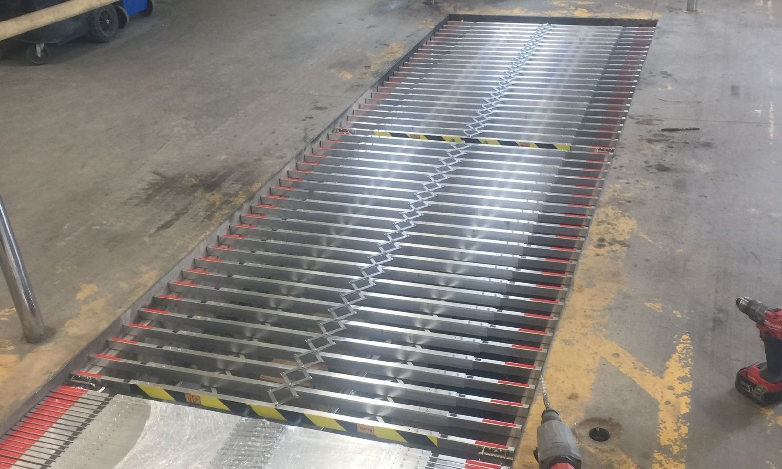 Maintenance pit safety barriers installed in a transit maintenance facility