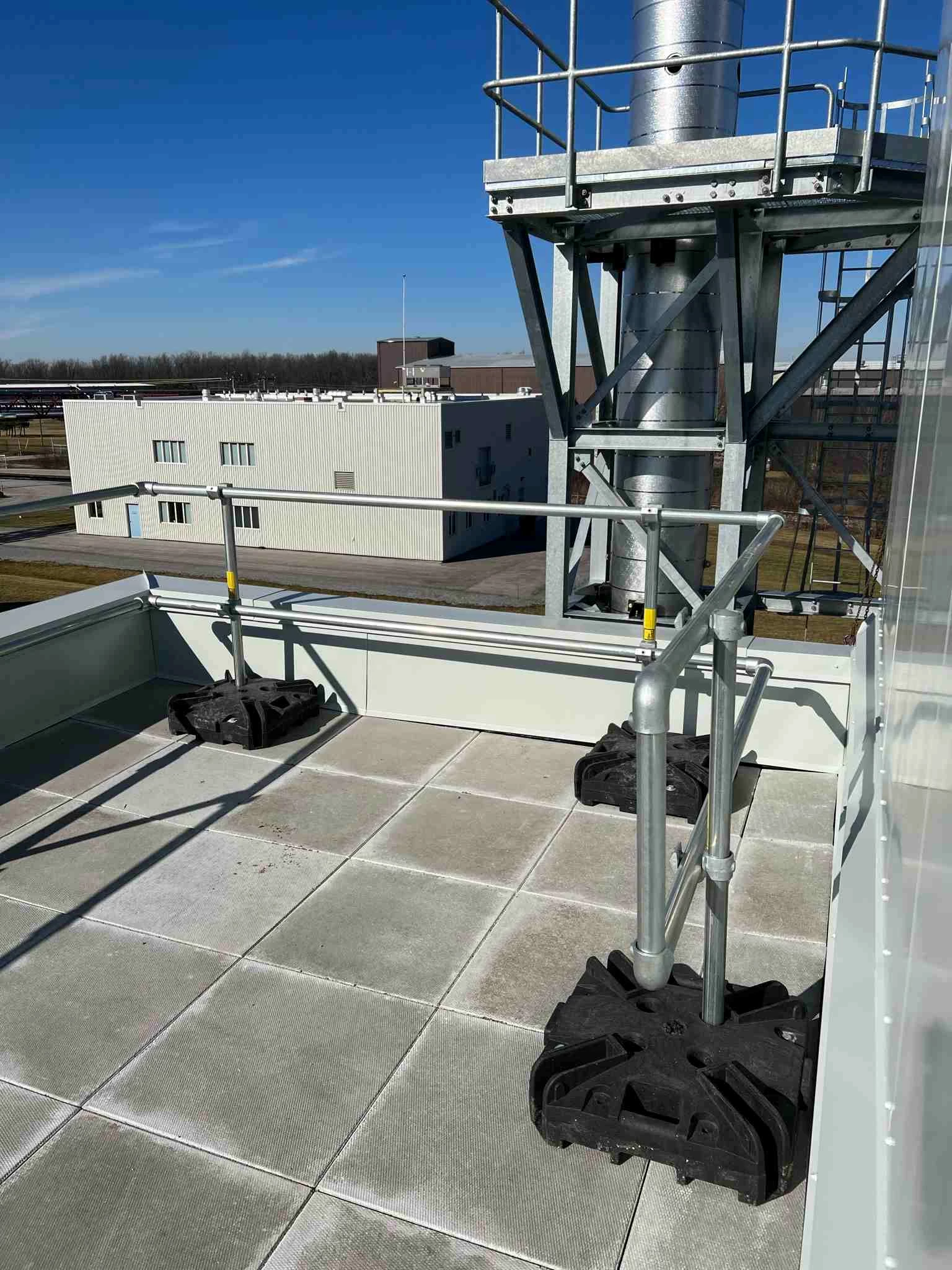 Kee Guard non-penetrating guardrail installed on a narrow rooftop edge / narrow roof fall protection / roof guardrails