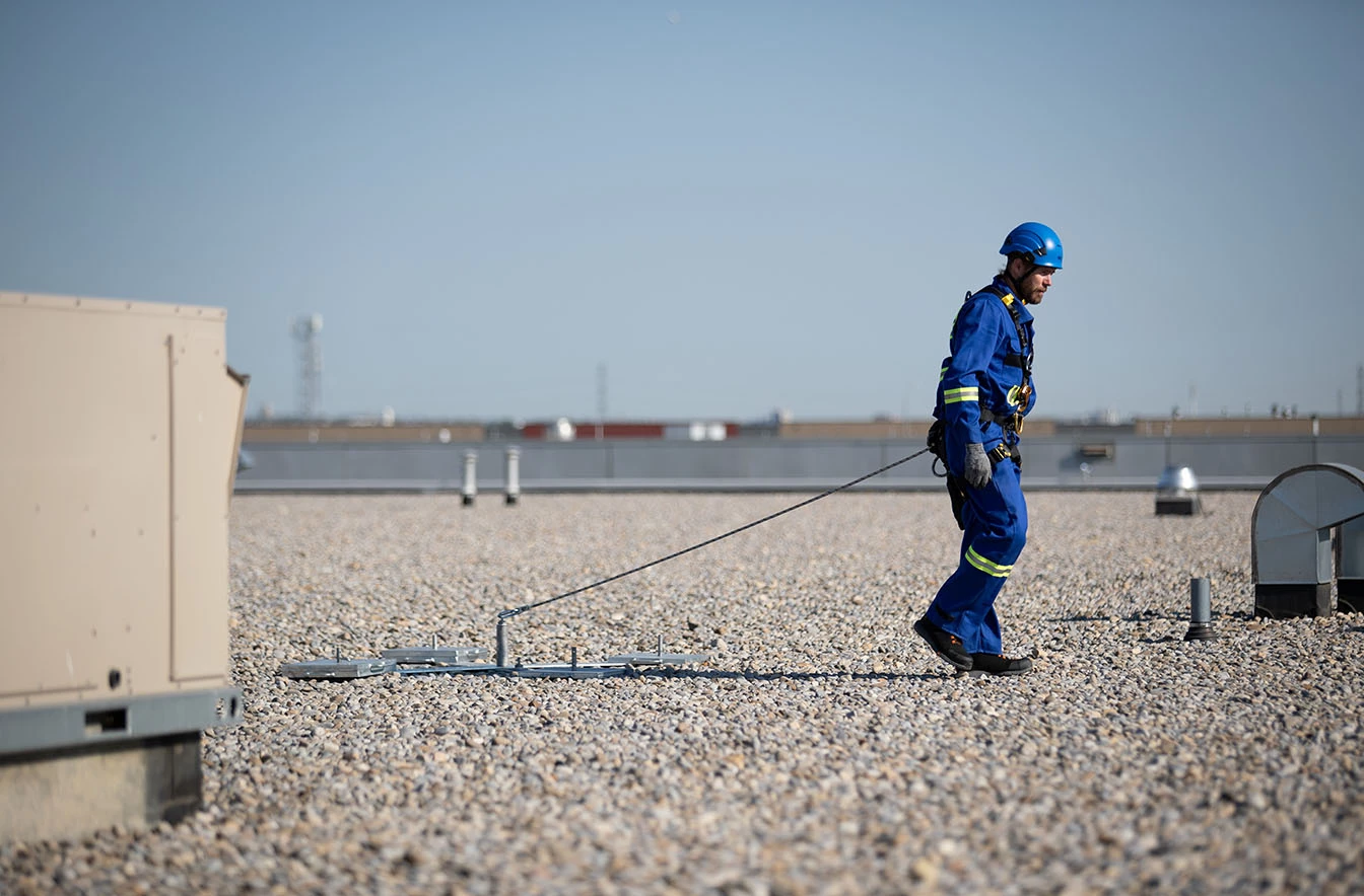 Worker secured with lanyard to Kee Anchor® in fall restraint setup