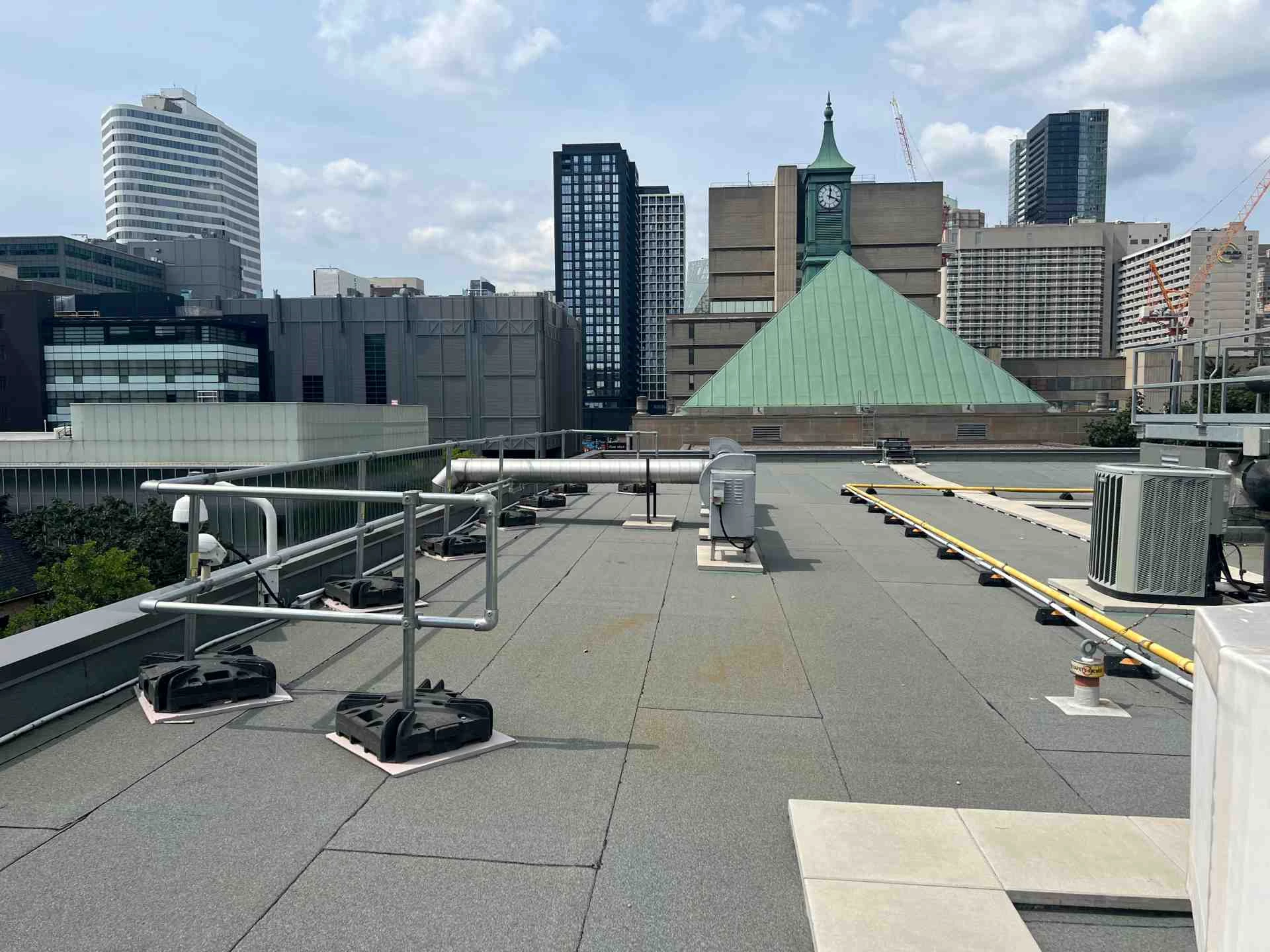 Kee Guard non-penetrating guardrail installed on a narrow rooftop edge in Toronto - Canada