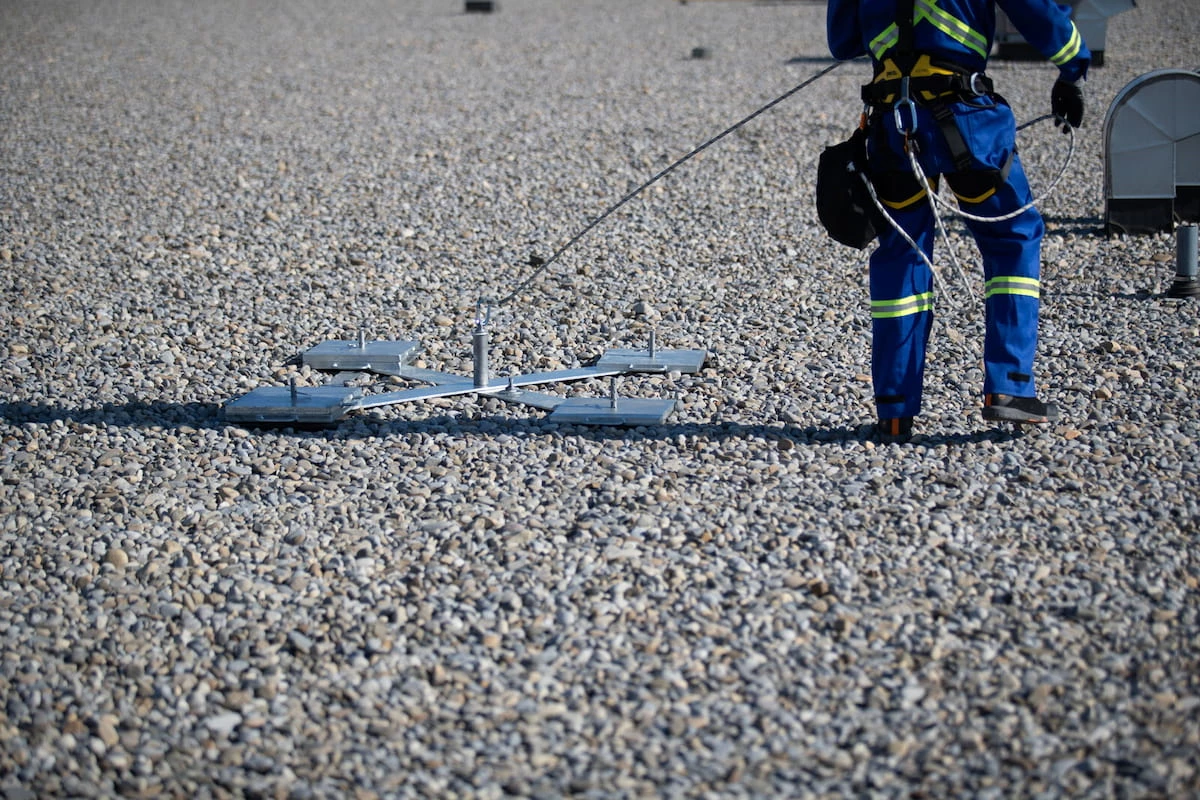 Worker secured with lanyard to Kee Anchor in fall restraint setup
