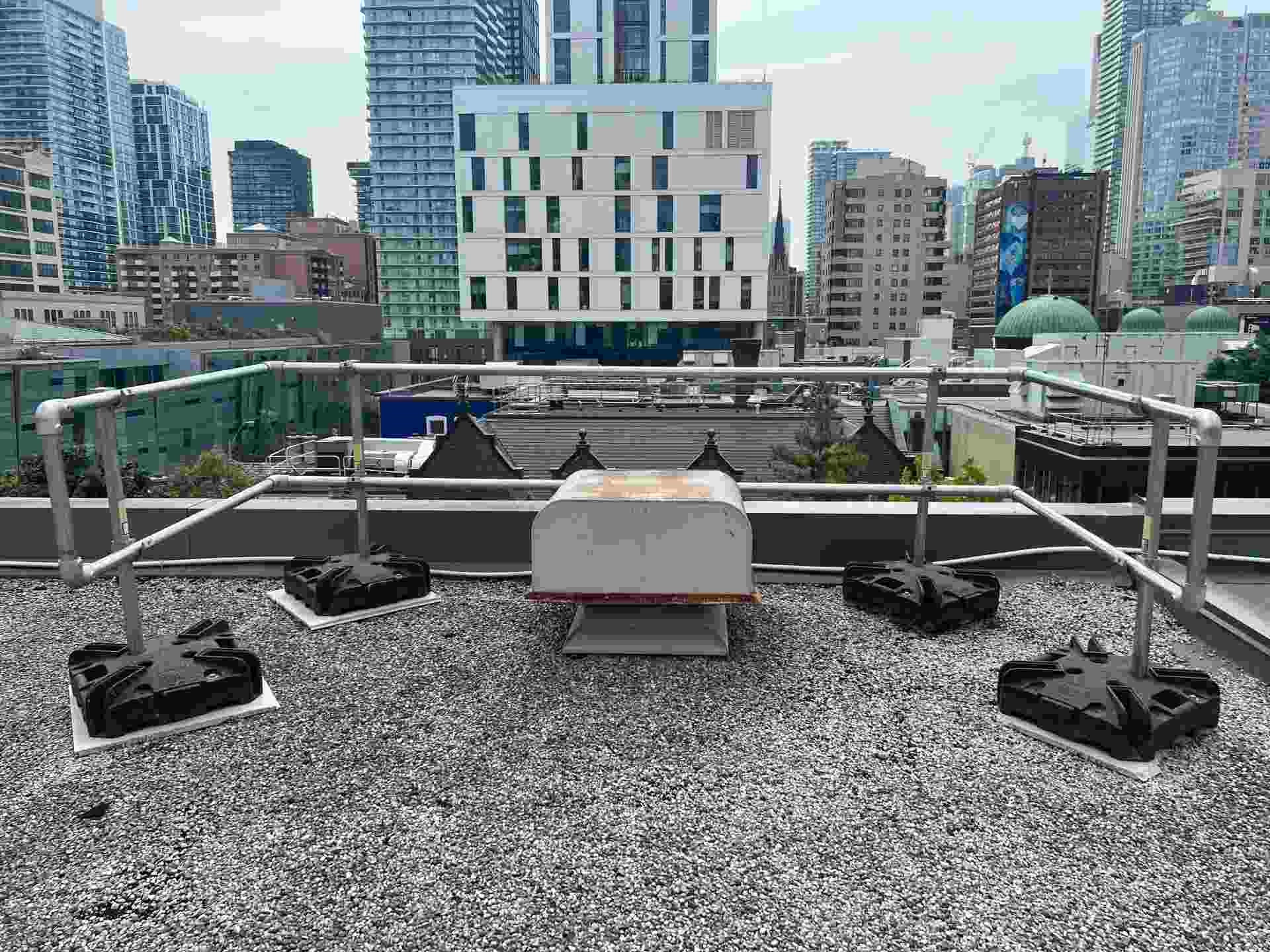 Kee Guard fall protection system installed along narrow commercial rooftop in Canada